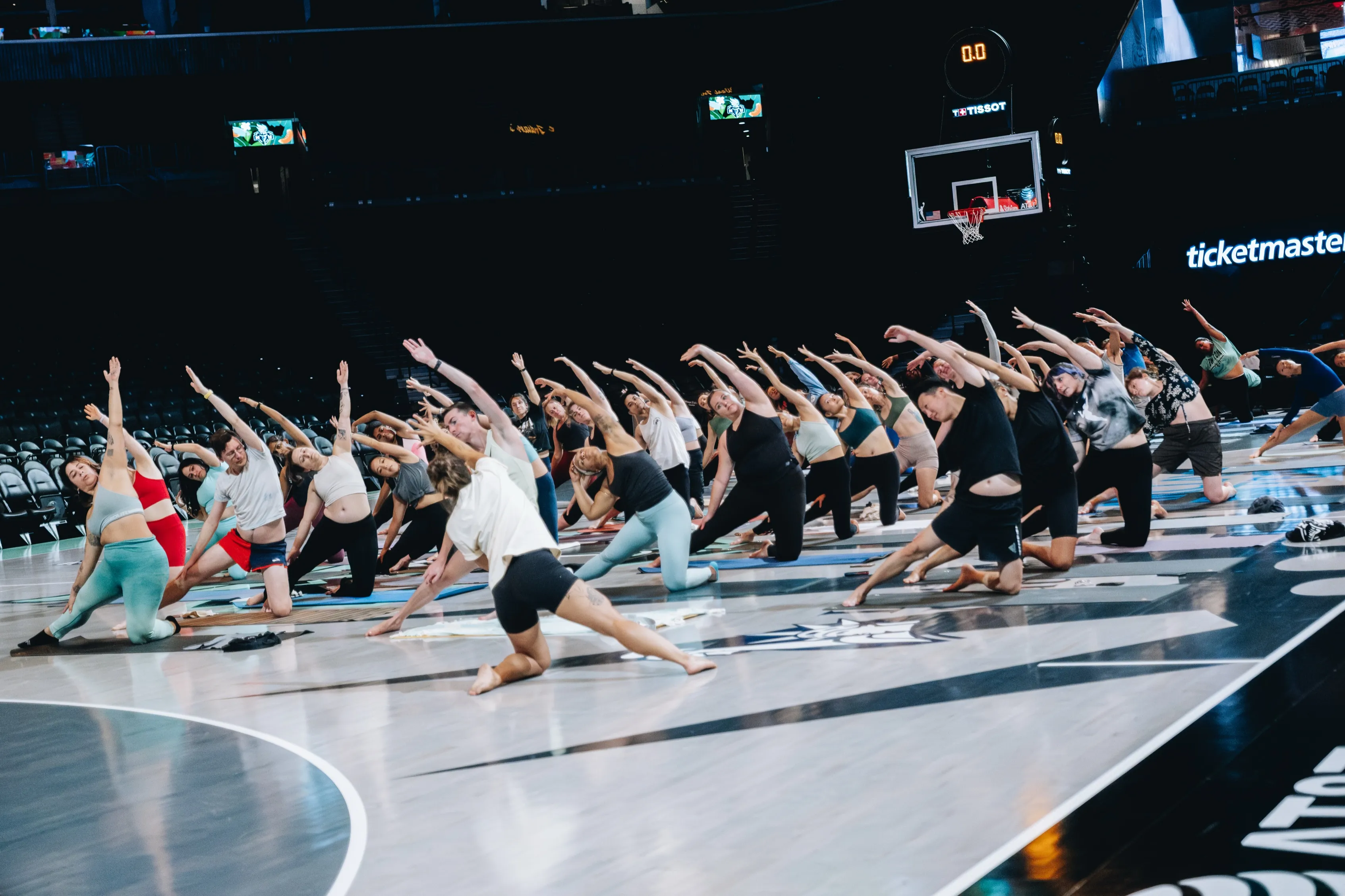Yogis practicing on the NY Liberty court at Barclays Center